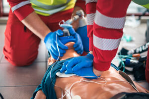 team of emergency medical service during cpr training on dummy